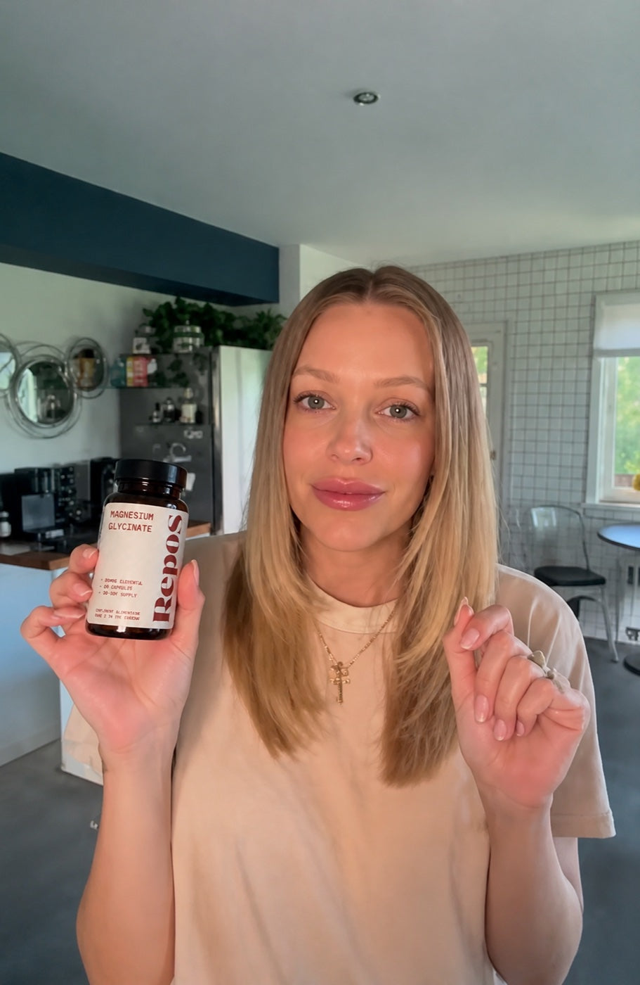 Customer showing her Repos magnesium glycinate jar in the kitchen